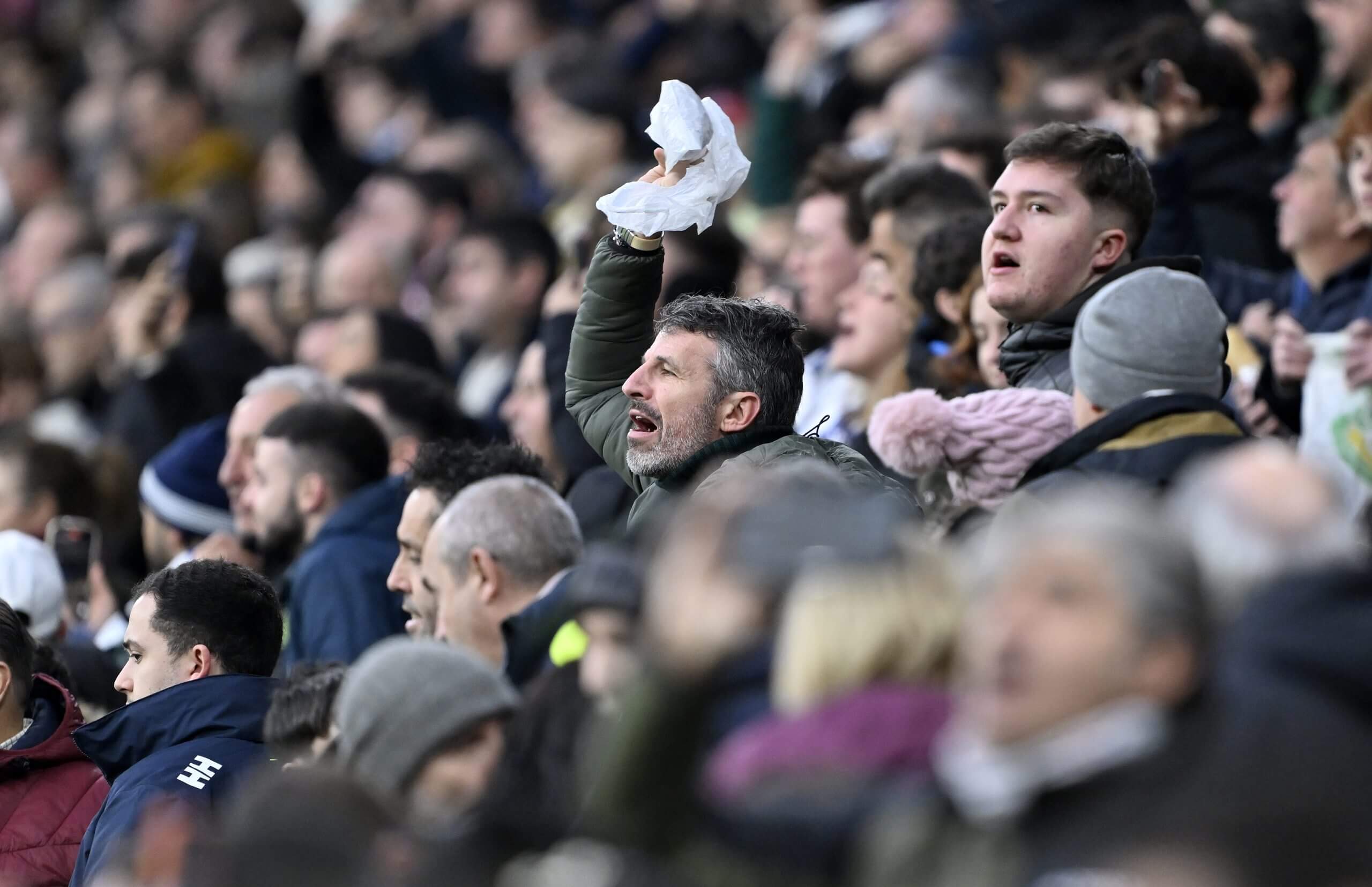 Why are angry Real Madrid fans waving white handkerchiefs?